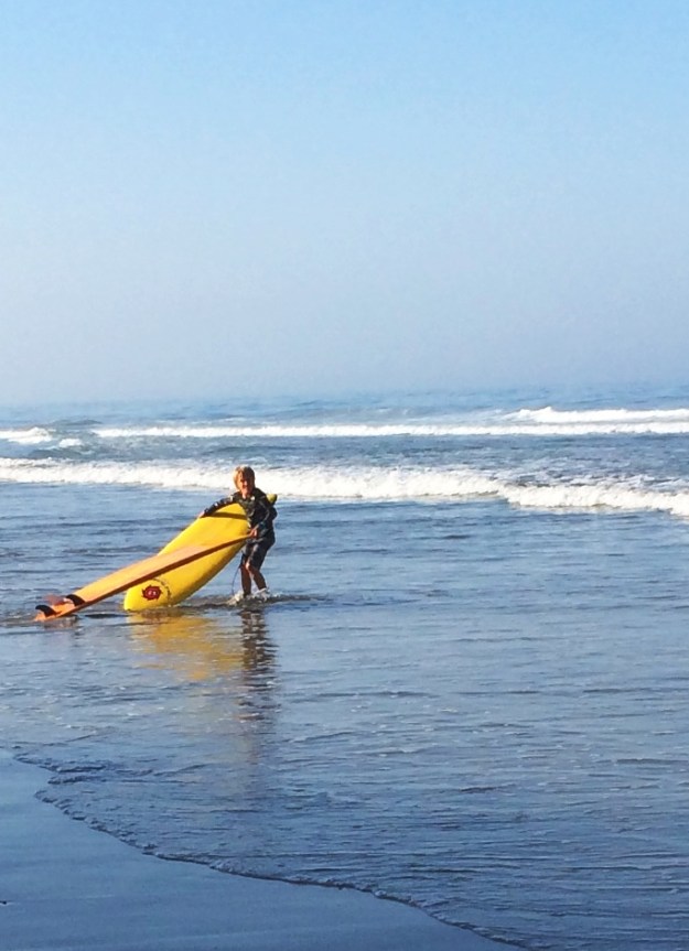 boy with two surfboards